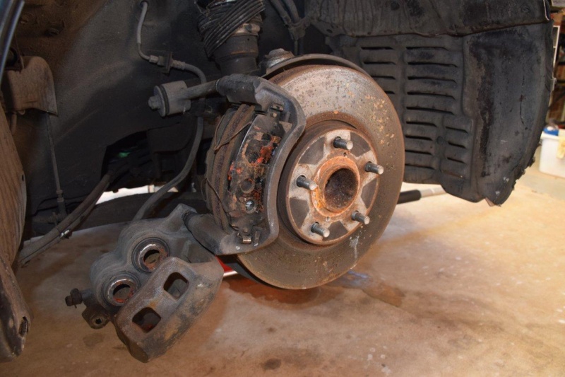 File:Front brake caliper unfolded to expose brake pads.jpg